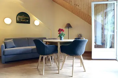 a living room with a table and a couch at Saint-Gervais apartment next to Bettex ski lift in Saint-Gervais-les-Bains