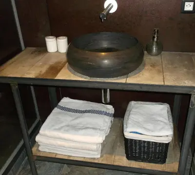 a shelf with towels and a sink in a bathroom at Appartement Résidence Astoria in Chamonix-Mont-Blanc
