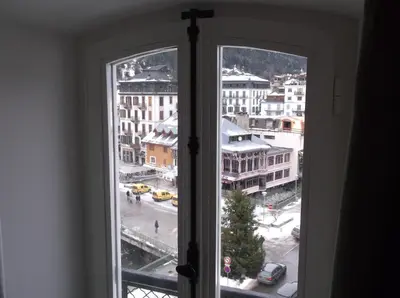 an open window with a view of a city at Appartement Résidence Astoria in Chamonix-Mont-Blanc