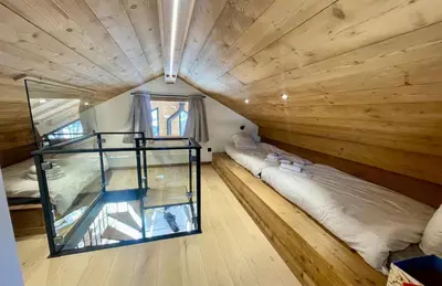 a room with two beds and a glass house at Megève - Chalet Yack - Premium jusqu'à 15 pers in Megève