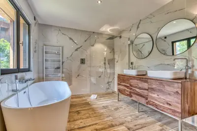 a bathroom with two sinks and a tub and mirrors at Megève - Chalet Yack - Premium jusqu'à 15 pers in Megève