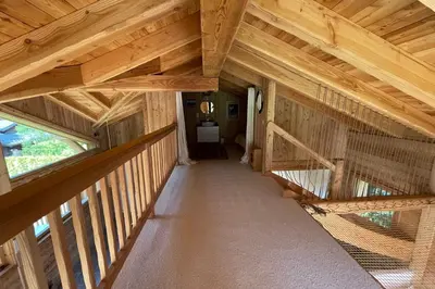 a room with a bird cage in a wooden house at Semi Detached Chalet For 8 With Balcony & Garden in Chamonix-Mont-Blanc