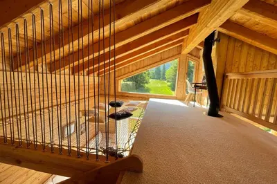 a living room with a couch and a table at Semi Detached Chalet For 8 With Balcony & Garden in Chamonix-Mont-Blanc