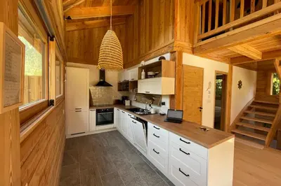 a dining room with a table and two chairs at Semi Detached Chalet For 8 With Balcony & Garden in Chamonix-Mont-Blanc