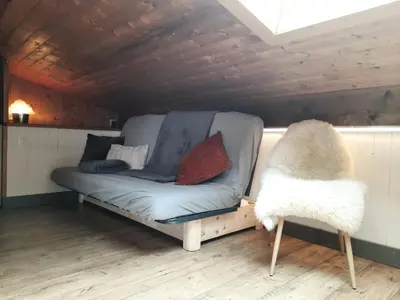 a couch and a chair in a room at Appartement en plein centre du village (6-8 personnes) in Les Contamines-Montjoie