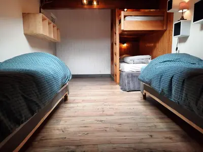 two bunk beds in a room with wooden floors at Appartement en plein centre du village (6-8 personnes) in Les Contamines-Montjoie