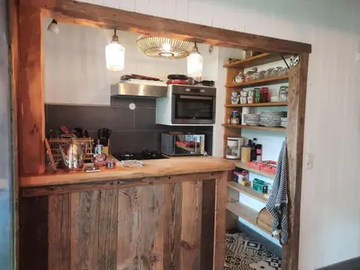 a kitchen with a wooden counter with a microwave at Appartement en plein centre du village (6-8 personnes) in Les Contamines-Montjoie