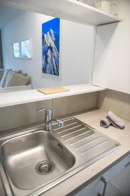 a kitchen with a sink and a counter top at Chamonix 27 - Au Centre Vue Mont Blanc et Jardin in Chamonix-Mont-Blanc