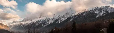a snowy mountain range with clouds in the sky at L'Abeille - Renovated - 4 bedroom - 8 person-110sqm - Views! in Les Houches