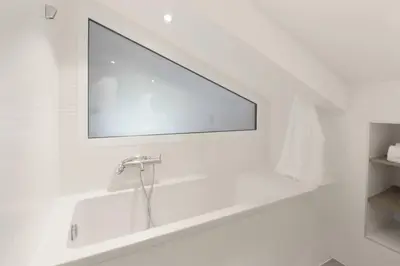 a white bathroom with a sink and a mirror at L'Abeille - Renovated - 4 bedroom - 8 person-110sqm - Views! in Les Houches