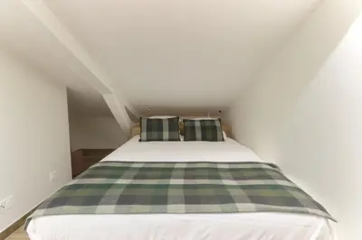 a bedroom with a bed with two green and white pillows at L'Abeille - Renovated - 4 bedroom - 8 person-110sqm - Views! in Les Houches
