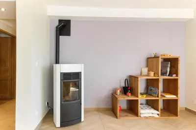 a living room with a stove and a shelf at L'Abeille - Renovated - 4 bedroom - 8 person-110sqm - Views! in Les Houches