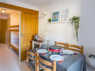a small kitchen with wooden cabinets and a microwave at Apartment Le Martagon 007 by Interhome in Saint-Gervais-les-Bains