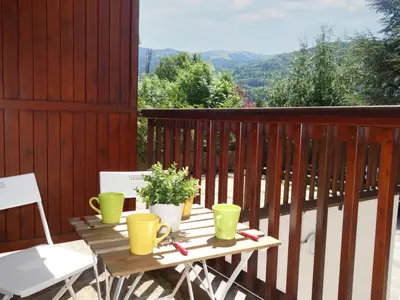 a living room with a couch with blue pillows at Apartment Le Martagon 007 by Interhome in Saint-Gervais-les-Bains