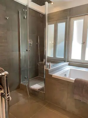 a bathroom with a shower and a bath tub at Appartement Mocca au coeur de Chamonix Mont-Blanc in Chamonix-Mont-Blanc