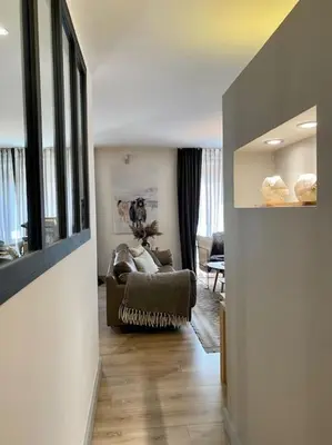 a living room with a couch and a chair in a room at Appartement Mocca au coeur de Chamonix Mont-Blanc in Chamonix-Mont-Blanc