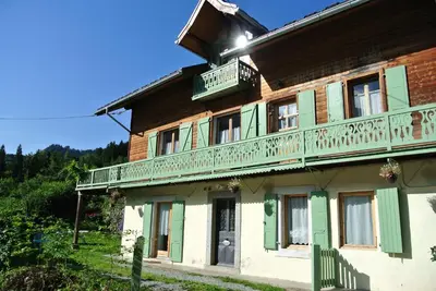 an old house with a balcony on top of it at Le Refuge in Saint-Gervais-les-Bains