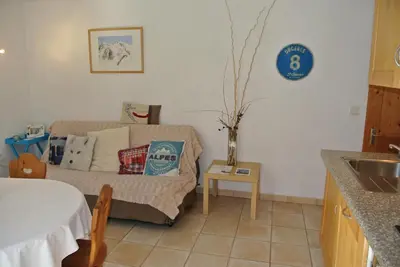 a living room with a couch and a table at Le Refuge in Saint-Gervais-les-Bains