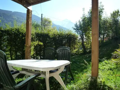a table and chairs sitting under a gazebo at Le Refuge in Saint-Gervais-les-Bains