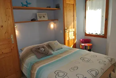 a bedroom with a bed and a window at Le Refuge in Saint-Gervais-les-Bains