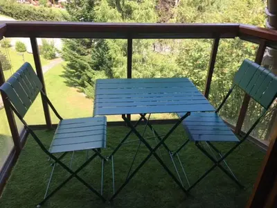 two chairs and a blue bench on a porch at L'enclaves in Les Contamines-Montjoie