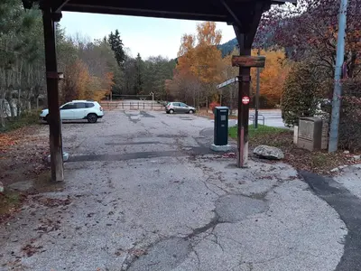 an empty parking lot with cars parked in a parking lot at L'enclaves in Les Contamines-Montjoie