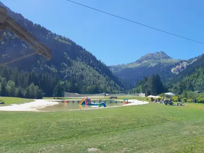 a park with a water park with a playground at L'enclaves in Les Contamines-Montjoie