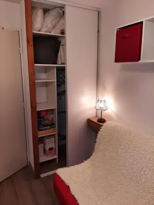a bedroom with a closet with a bed and a lamp at L'enclaves in Les Contamines-Montjoie