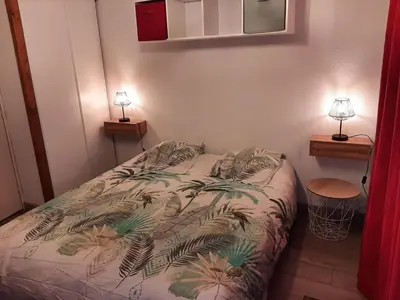 a bedroom with a bed and two lamps on two tables at L'enclaves in Les Contamines-Montjoie