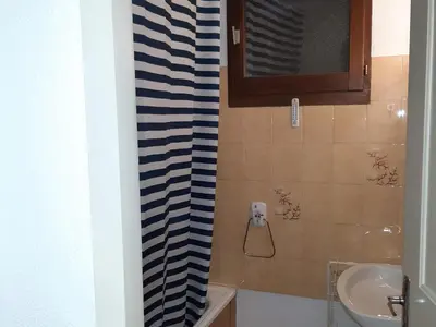 a bathroom with a blue and white shower curtain at T2 calme avec parking et wifi à Chamonix - FR-1-517-64 in Chamonix-Mont-Blanc