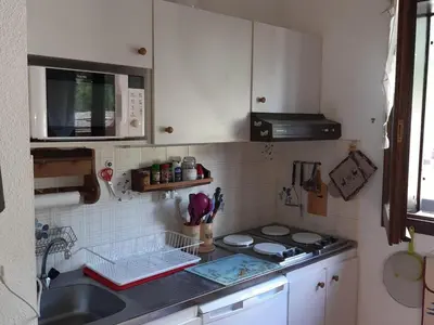 a small kitchen with a sink and a stove at T2 calme avec parking et wifi à Chamonix - FR-1-517-64 in Chamonix-Mont-Blanc