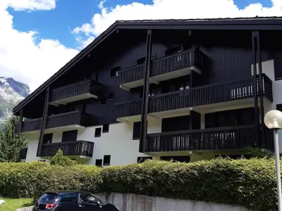 a black and white building with a car parked in front at T2 calme avec parking et wifi à Chamonix - FR-1-517-64 in Chamonix-Mont-Blanc