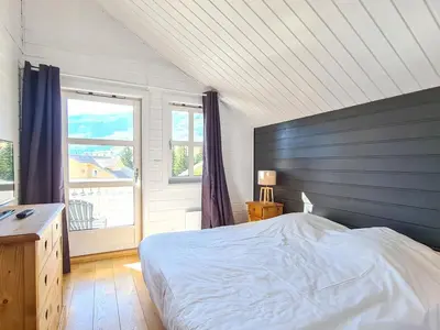 a bedroom with a bed and a large window at Chalet spacieux avec poêle à bois, WIFI gratuit, terrasse, garage et proche des pistes - FR-1-425-122 in Flaine