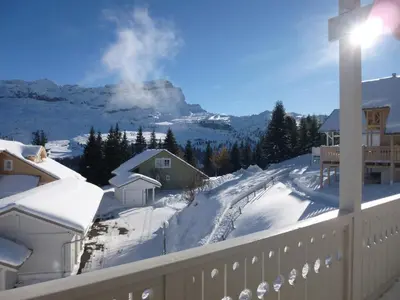 a snow covered balcony with a view of a mountain at Chalet spacieux avec poêle à bois, WIFI gratuit, terrasse, garage et proche des pistes - FR-1-425-122 in Flaine