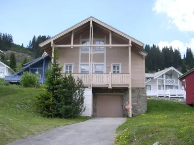 a large house with a porch and a garage at Chalet spacieux avec poêle à bois, WIFI gratuit, terrasse, garage et proche des pistes - FR-1-425-122 in Flaine