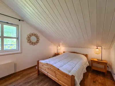 a bedroom with a bed and a window at Chalet spacieux avec poêle à bois, WIFI gratuit, terrasse, garage et proche des pistes - FR-1-425-122 in Flaine