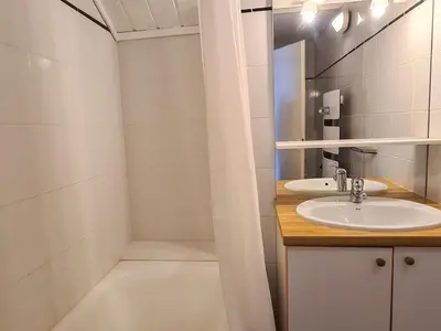 a bathroom with a sink and a bath tub at Chalet spacieux avec poêle à bois, WIFI gratuit, terrasse, garage et proche des pistes - FR-1-425-122 in Flaine