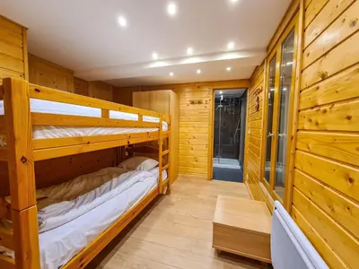 a room with two bunk beds in a cabin at Chalet lumineux avec poêle à bois et WIFI gratuit - 6 à 8 personnes - Garage - FR-1-425-117 in Flaine