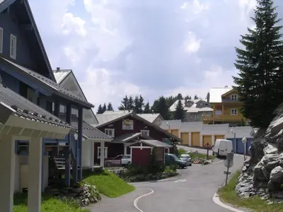 a street in a small town with houses at Chalet lumineux avec poêle à bois et WIFI gratuit - 6 à 8 personnes - Garage - FR-1-425-117 in Flaine