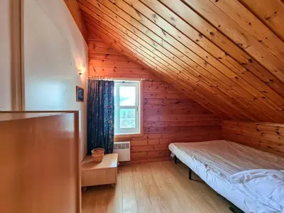 a bedroom with a bed and a wooden ceiling at Chalet lumineux avec poêle à bois et WIFI gratuit - 6 à 8 personnes - Garage - FR-1-425-117 in Flaine