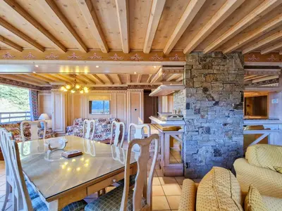 a dining room with a table and a stone wall at Appartement spacieux avec sauna et grande terrasse, pour 10 pers. - FR-1-425-118 in Flaine