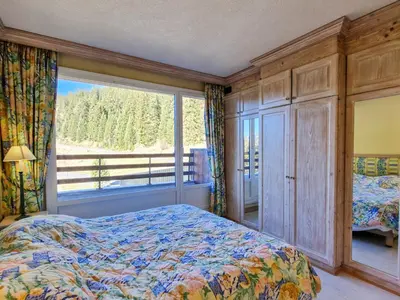 a bedroom with a bed and a large window at Appartement spacieux avec sauna et grande terrasse, pour 10 pers. - FR-1-425-118 in Flaine