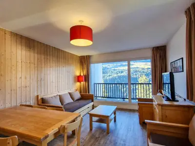 a living room with a couch and a table at Appartement spacieux au centre, balcon, animaux acceptés - FR-1-425-130 in Flaine