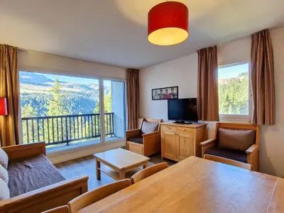 a living room with a table and a large window at Appartement spacieux au centre, balcon, animaux acceptés - FR-1-425-130 in Flaine