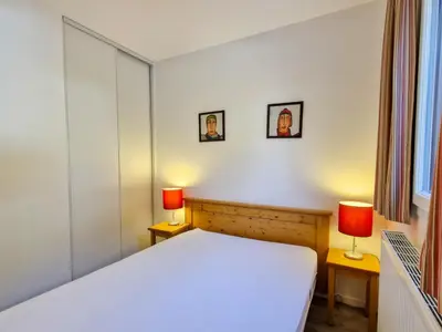 a bedroom with a white bed and two lamps at Appartement spacieux au centre, balcon, animaux acceptés - FR-1-425-130 in Flaine