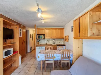 a kitchen and dining room with a table and chairs at Appartement 3 pièces confortable au centre de Flaine avec terrasse - FR-1-425-135 in Flaine