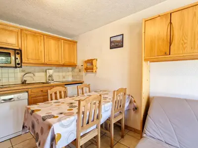 a kitchen with a table and chairs in a room at Appartement 3 pièces confortable au centre de Flaine avec terrasse - FR-1-425-135 in Flaine