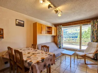 a room with a table and a bed and a window at Appartement 3 pièces confortable au centre de Flaine avec terrasse - FR-1-425-135 in Flaine