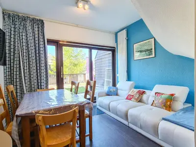 a living room with a couch and a table at Appartement lumineux au pied des pistes avec piscine et spa - FR-1-425-133 in Flaine