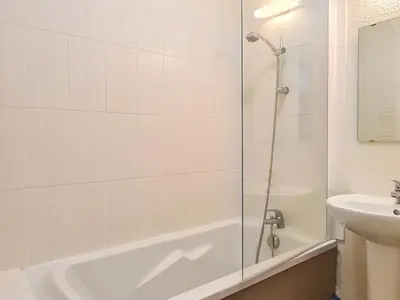 a bathroom with a shower and a tub and a sink at Appartement lumineux au pied des pistes avec piscine et spa - FR-1-425-133 in Flaine